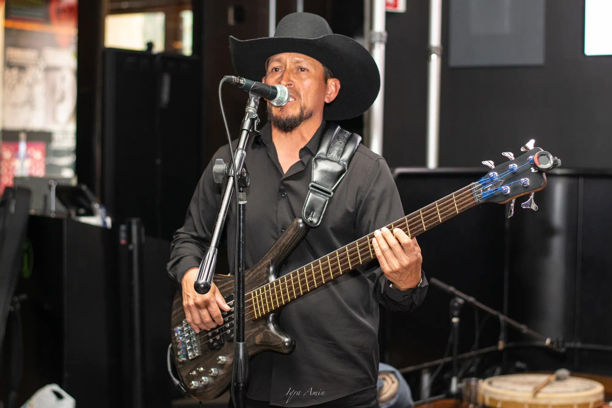 Bassist in a cowboy hat singing