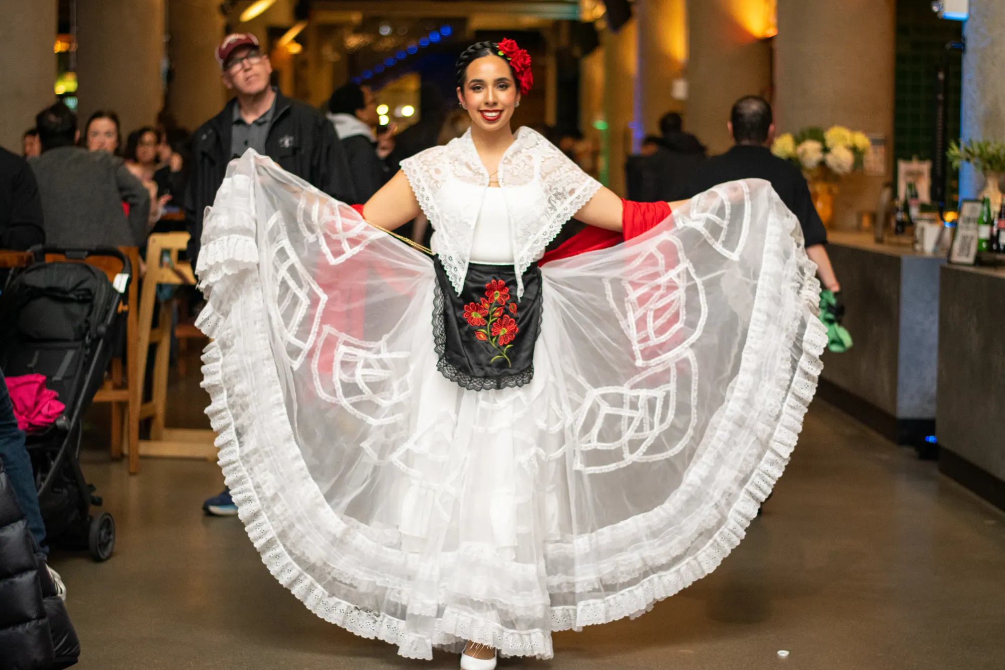 Folk dancer opening her white lace skirt