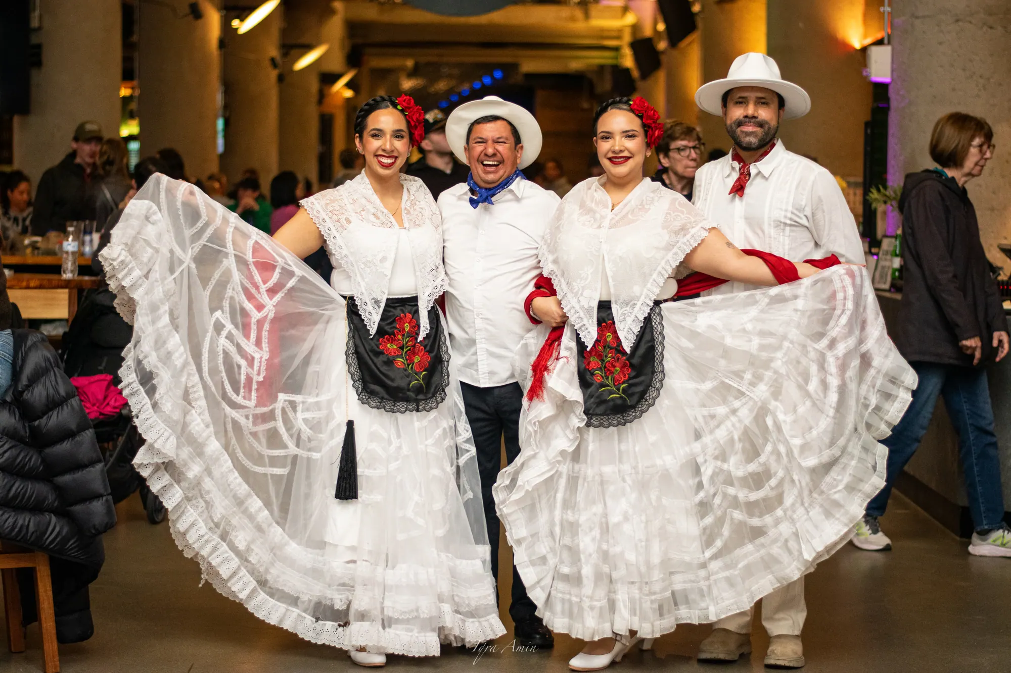 Two folk dancers and two musicians smiling at Time Out Market