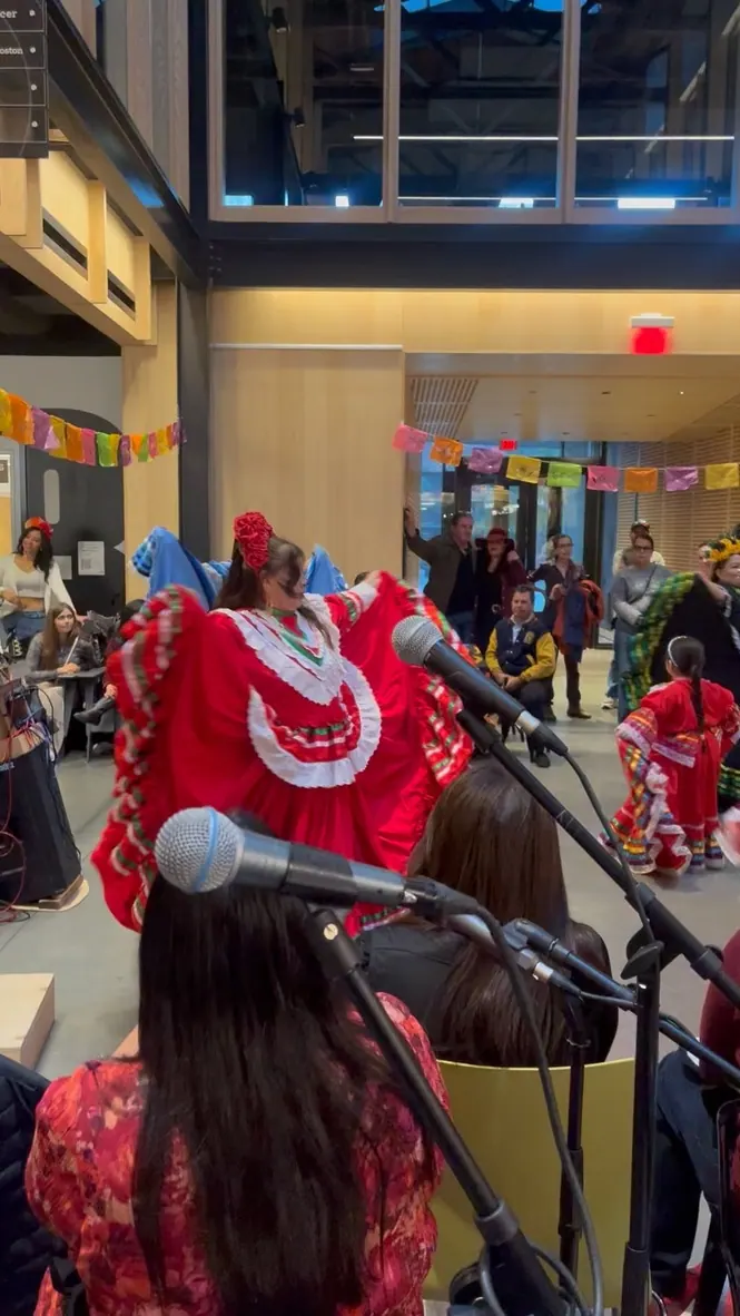 Folk dancers under papel picado at The Foundry